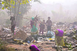The family of a labourer salvages the remnants after their temporary houses were razed during an anti-encroachment drive in Jammus Narwal area