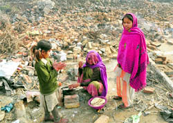 A woman cooks food in the open