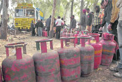Residents queue up to collect LPG refills at Satwari Chowk in Jammu