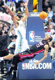 Miami Heats James Jones (R) fouls Denver Nuggets Arron Afflalo (L) during their NBA basketball game in Denver, Colorado on Friday.