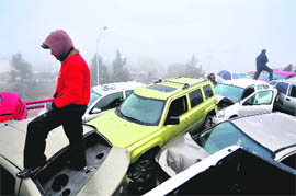 THE GREAT PILE-UP: Drivers stand over vehicles after an accident involving 30 cars on a Saltillo road, in Mexican state of Coahuila, on Thursday. 