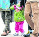 A child walks with his parents on a cold Saturday afternoon at Sector 17 in Chandigarh.