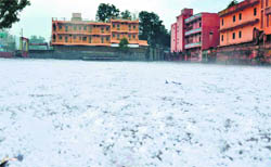 The playground of Kanya Arya Inter College, Kankhal, covered with hailstones in Haridwar on Saturday