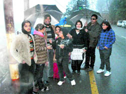 Tourists in Mussoorie take a stroll in the city streets in anticipation of snowfall