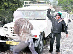 Taxi drivers play with balls of hailstones in Haridwar on Saturday