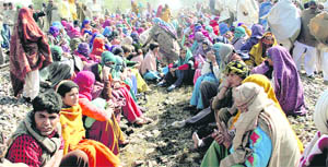 Members of the Sarvajatiya Sarvakhap Mahapanchayat stage a dharna on a rail track near Julani village in Jind on Saturday.
