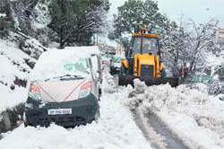 Snow on the road to McLeodganj near the Dharamsala Cantt area being cleared