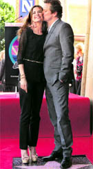 British actor Colin Firth poses with wife, Italian film producer Livia Giuggioli as they stand atop his newly unveiled star on the Hollywood Walk of Fame in Hollywood, California