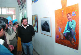 Vice-chancellor of the Central University of Punjab Jairup Singh admires a painting on the inaugural day of the Art 2010 at the Teachers' Home in Bathinda on Sunday. 
