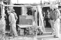Policemen carry out a search in a slum area of Zirakpur on Sunday