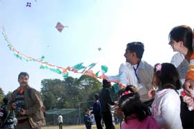 People enjoy the flying of kites during Uttarayan at Sardar Patel Vidyalaya in New Delhi on Sunday.