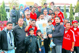 Members of the Doon Hawks team with the trophy in Dehradun on Sunday