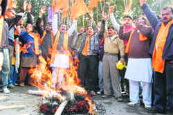Shiv Sena workers burn an effigy of the Centre and the state government in Dehradun on Sunday. A Tribune photograph