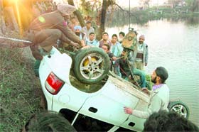 The car that fell into a pond near Noorpur village in Ambala being retrieved on Sunday.