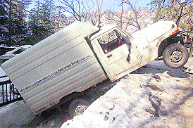 A vehicle skids off a slippery road in Shimla on Sunday.