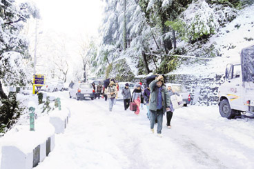 Residents carry their luggage due to suspension of bus services in Dalhousie on Sunday.