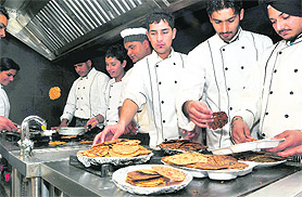 Students of UEI Global College prepare paranthas during the Parantha Fest in Ludhiana on Sunday.