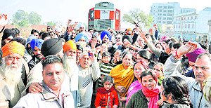 Irate residents block the Ludhiana-Ferozepur railway track near the Lodhi Club to protest against the closure of a manned level crossing in Ludhiana on Sunday.