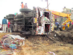 The overturned truck and the mangled remains of the rickshaw at Chahal Nagar Chowk in Phagwara on Sunday.