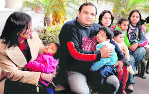 Tired toddlers sleep in the arms of their harassed parents at the UT Secretariat in Chandigarh on Monday.