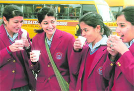 Schools girls catch up their friends after winter vacation.