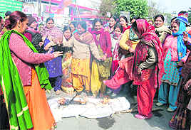 Members of the BJP Mahila Morcha burn an effigy of the Central Government against the hike in petrol prices in Dehradun on Monday. 