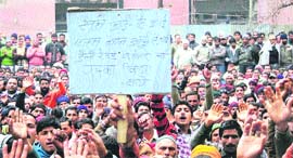 Members of the PHE Employees United Front hold a demonstration in support of their demands in Jammu on Monday.