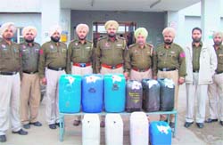 Fatehgarh Sahib policemen with the confiscated liquor.