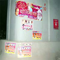 Posters containing photographs of political leaders on a pillar are left unremoved in Amritsar.