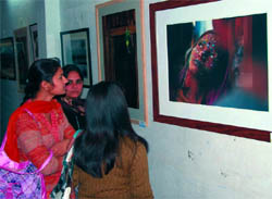 Visitors take a look at a painting on the concluding day of the Art-2010, an exhibition organised by the Punjab Lalit Kala Akademi, at the Teachers Home in Bathinda on Tuesday.
