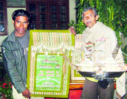 Bamboo craftsmen Mahesh R Ojha (right) and Asraf display their products