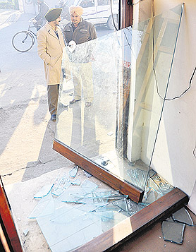 Cops examine a cybercafe at Dugri where theft was attempted on Monday night.