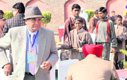 Children work as waiters during the state-level NRI Sammelan in Jalandhar on Tuesday.