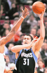 Minnesota Timberwolves center Darko Milicic (31) shoots over Portland Trail Blazers center Marcus Camby (L) during their NBA game in Oregon on Monday.