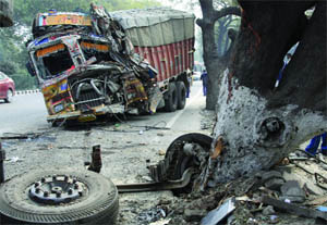 A damaged truck parked on the roadside after it crashed into a tree on Badarpur Road in New Delhi on Wednesday.