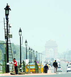 Workers set up lights and cameras for the Republic Day function at Vijay Ckowk in New Delhi on Wednesday.