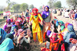 Women supporters of the mahapanchayat block the rail track near Jind on Wednesday. 