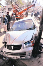 A Maruti car which hit a passenger shed at the Canal Road police post in Jammu