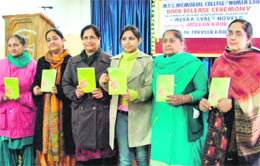 Principal Dr Parveen Kaur Chawla (third from left) releases a book written by college lecturer Jasleen Kaur (fourth from left) in Ludhiana on Wednesday