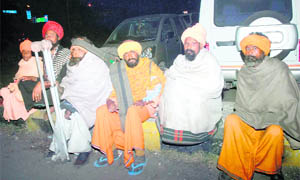 Pipan Nath (in a red turban) sits with other sadhus on a footpath near Jalandhar railway station.