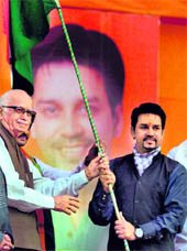 BJP leader LK Advani presents the National Flag to Bharatiya Janta Yuva Morcha president Anurag Thakur during the Rashtriya Ekta Yatra, which was 
