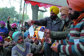 Leaders of various unions burn copies of the Punjab Prevention of Damage to Public and Private Property Bill-2010 and the Punjab Special Security Group Bill-2010 during a rally held outside the Mini-secretariat in Bathinda on Thursday