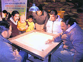 A match in progress at the second carrom tournament in Mussoorie on Friday.