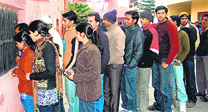Applicants line up at SMJN College to enquire about the availablity of forms in Haridwar on Thursday.