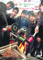 Students burn rolls of China-made kite string, the use of which has caused injuries, during a campaign in Amritsar
