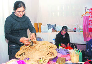Members of the four-woman team from Myanmar showcase their lotus fabric scarves and lacquerware