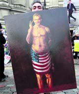 A demonstrator holds a painting of former Prime Minister Tony Blair outside the Queen Elizabeth II Conference Centre in London. Blair appeared on Friday before an inquiry into the Iraq War, detailing reasons for joining the controversial invasion.