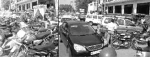 Two-wheelers and cars parked in a haphazard manner near a hotel at Leela Bhawan Chowk in Patiala