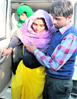 Suman, who was transfused wrong blood at the GMSH, Sector 16, being helped out of a car after being discharged from the hospital in Chandigarh