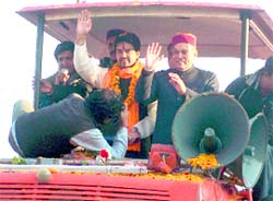 PK Dhumal and BJYM chief Anurag Thakur in an open jeep at Una on Saturday.